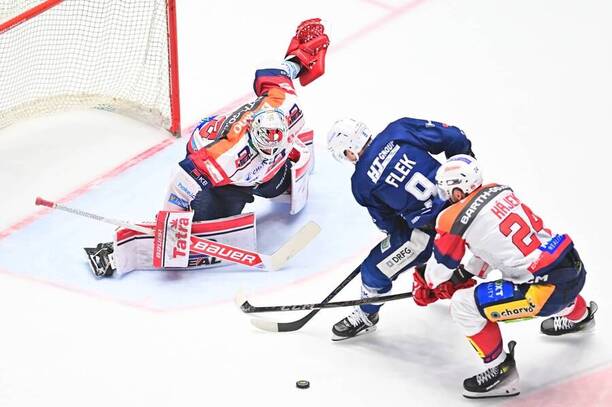 Jakub Flek z Komety Brno se řítí na brankáře Pardubic Romana Willa