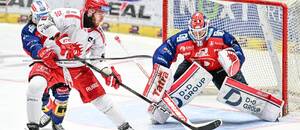 Třinecký Martin Marinčin před pardubickým brankářem Romanem Willem